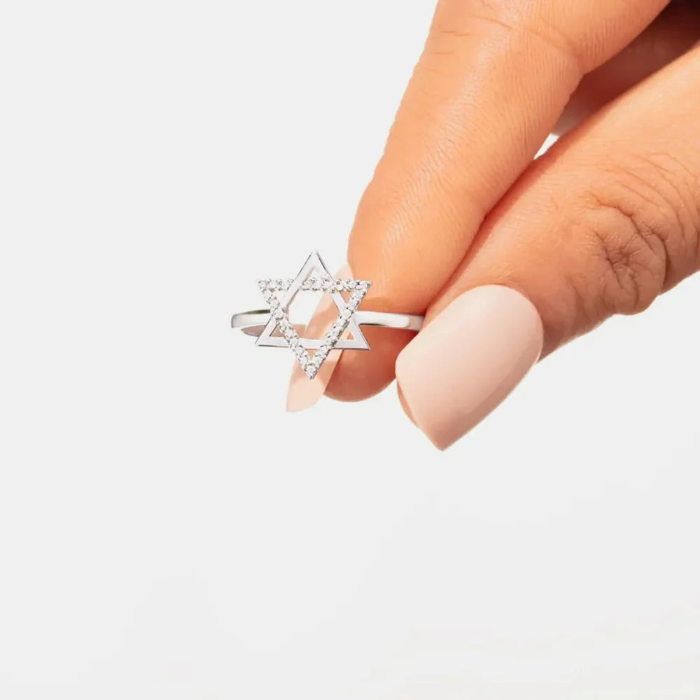 Star of David ring with white zirconia stones on a silver band.