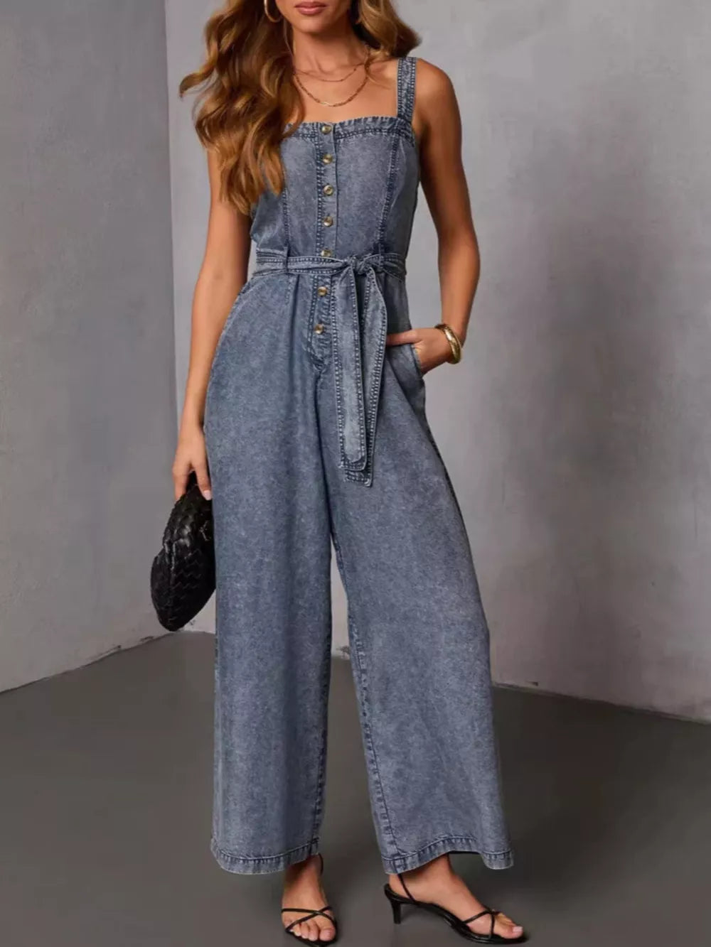 jumpsuit in washed denim blue featuring button-front bodice and wide-leg fit
