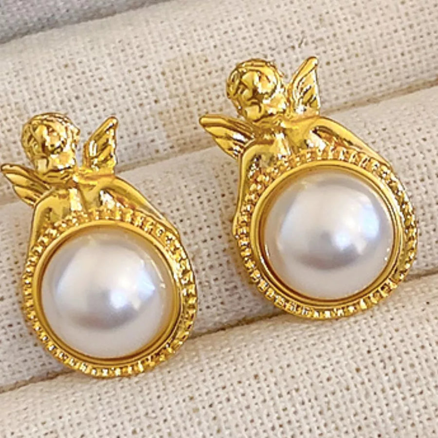 ivory earrings featuring angel motif and figurative
