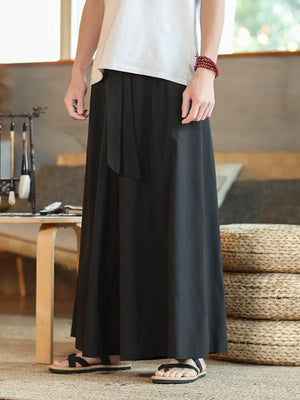 Black men's relaxed fit sweatpants with drawstring detail and wide leg.