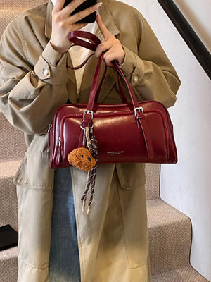 Deep Red leather shoulder bag with buckle details and a teddy bear charm