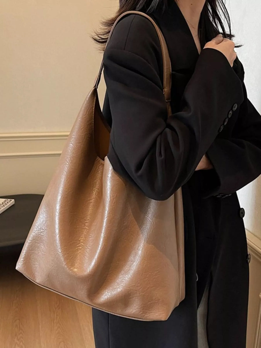 Sculptural PU leather tote bag in coffee color with a slouchy silhouette and single strap.
