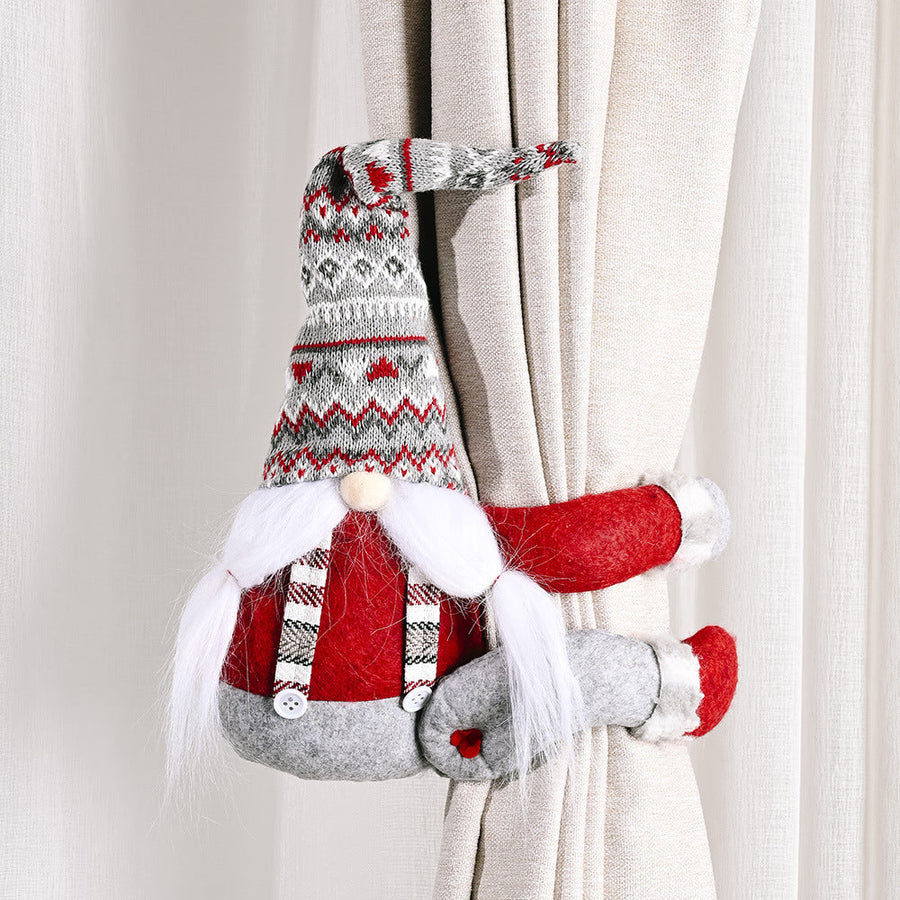 Whimsical gnome curtain tie-backs in red and gray knit with white beard and pom-pom nose.