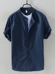Navy blue linen short sleeve band collar shirt with rolled cuffs.