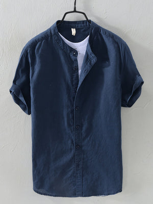 Navy blue linen short sleeve band collar shirt with rolled cuffs.