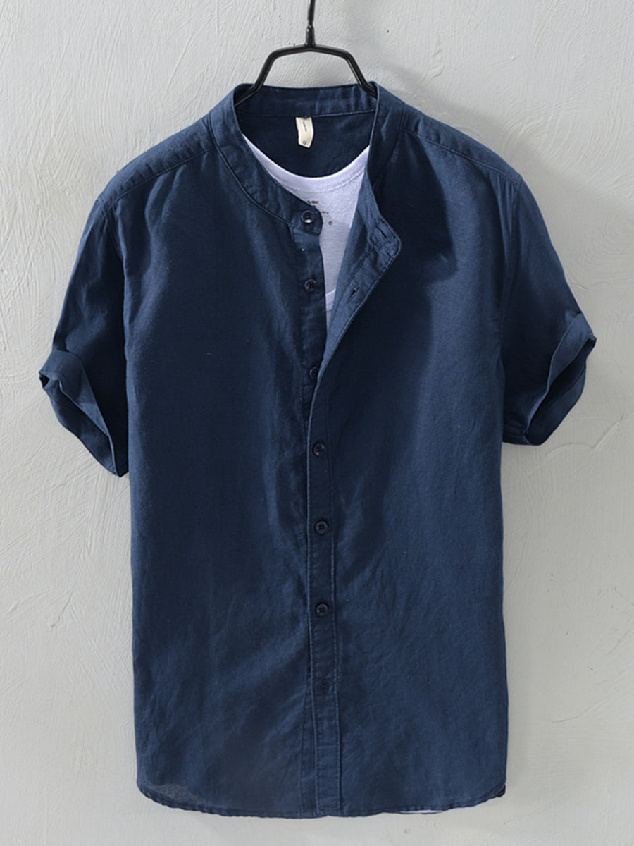 Navy blue linen short sleeve band collar shirt with rolled cuffs.