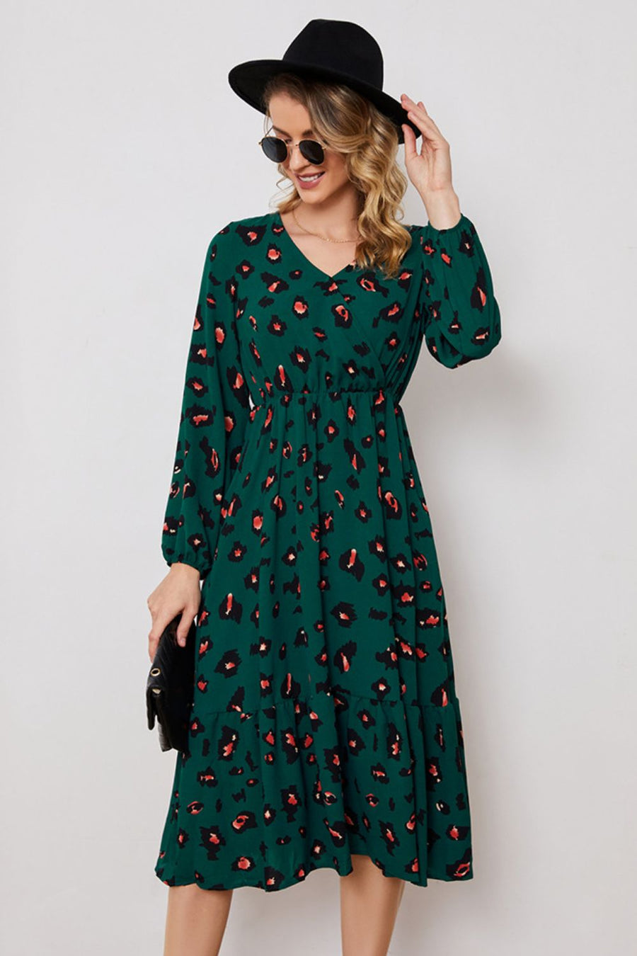 Emerald leopard print midi dress with balloon sleeves and a tiered hem.
