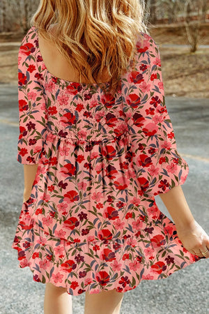Floral smocked mini dress in pink with red floral print, square neckline, and puff sleeves.