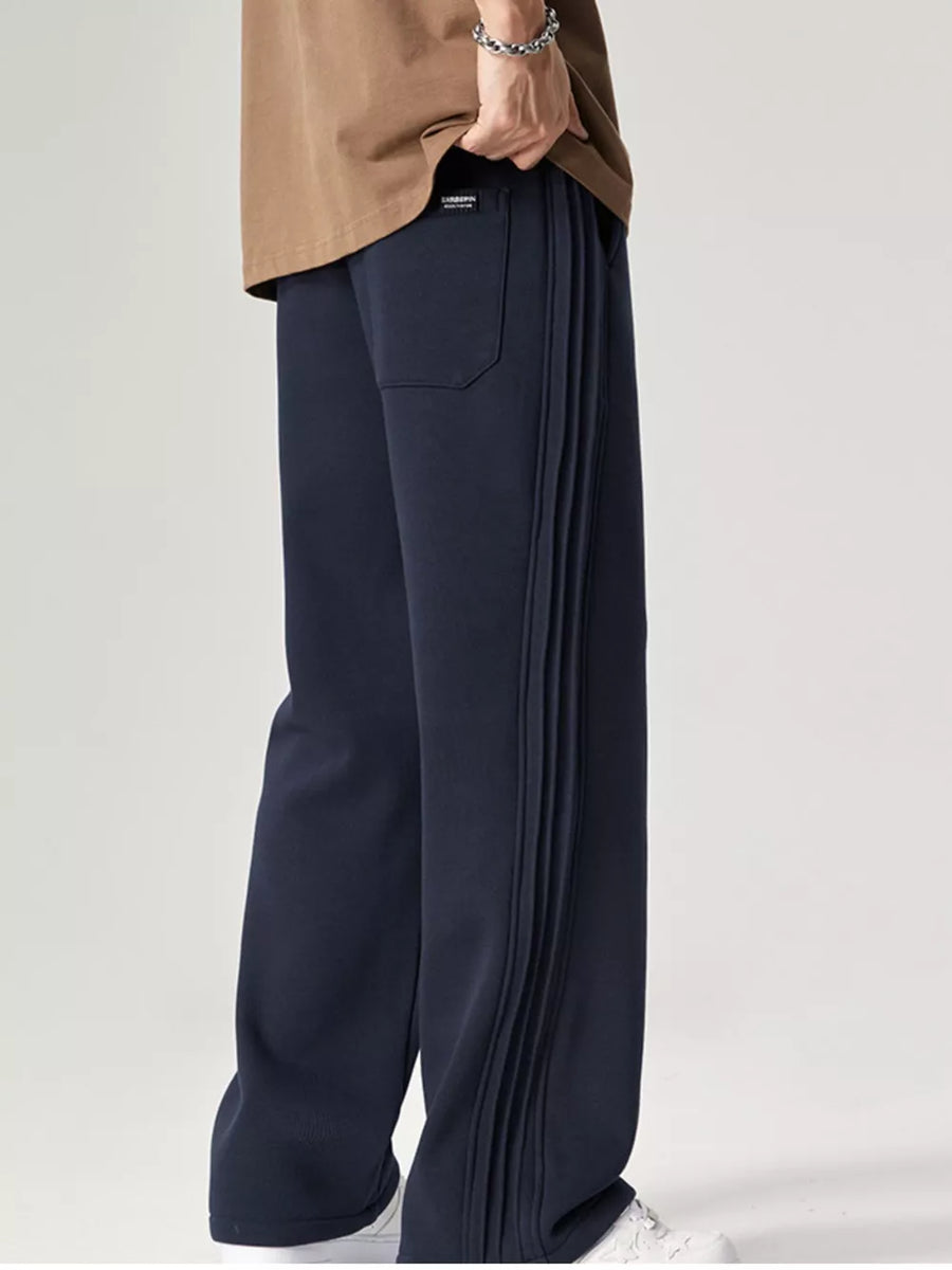 Men's dark navy relaxed fit sweatpants with pleated side stripe detail.