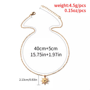 Gold sunburst pendant necklace with lace trim detail, 18K gold-plated chain.