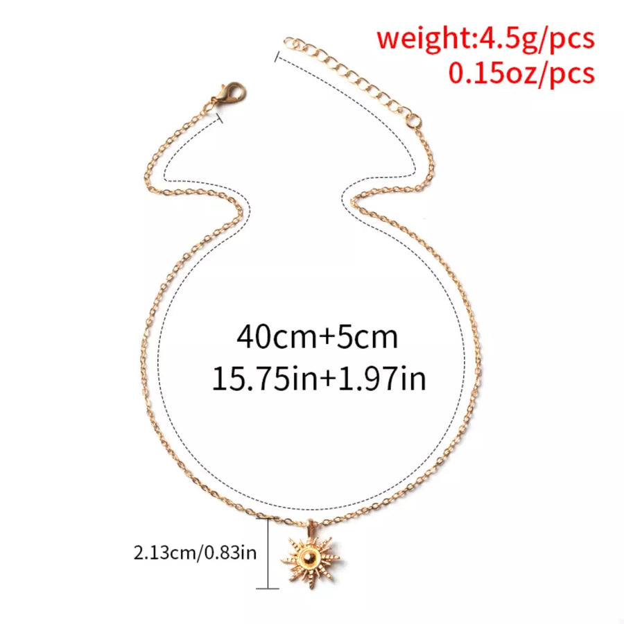 Gold sunburst pendant necklace with lace trim detail, 18K gold-plated chain.