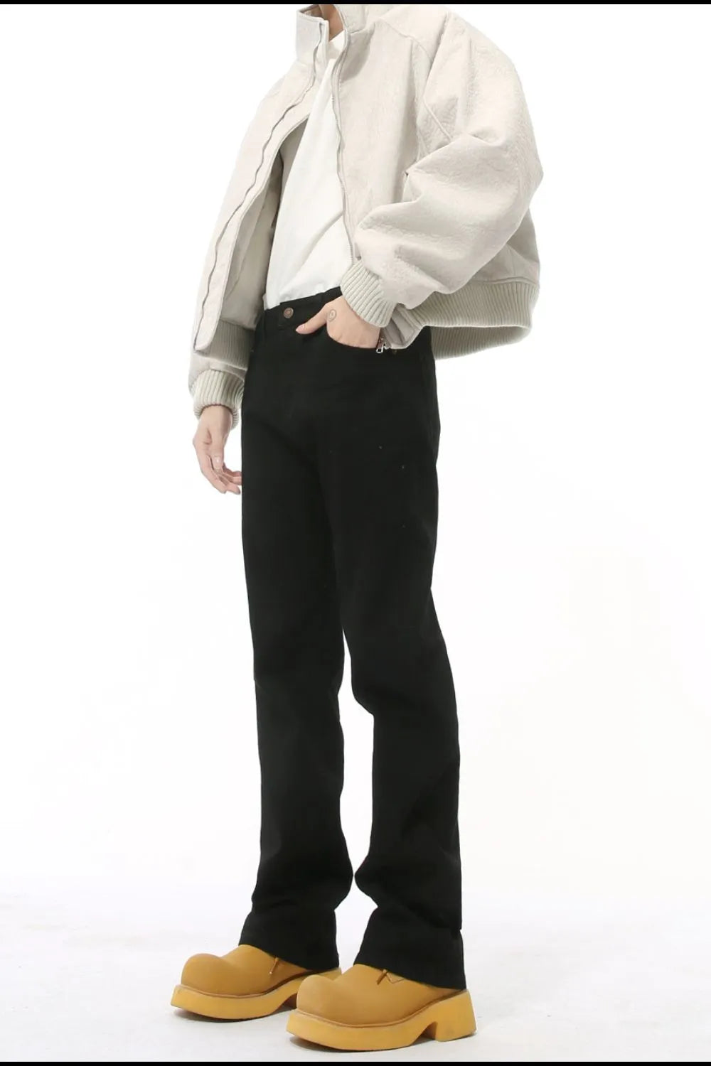 Black denim jeans with split hem and a tailored fit.
