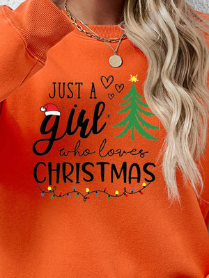 Orange Christmas graphic sweatshirt with text and holiday lights.