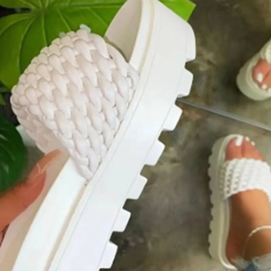 White woven platform slide sandals with chunky sole.