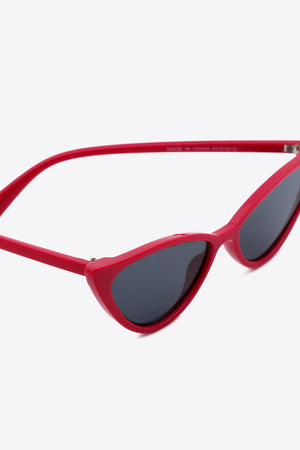 Crimson cat-eye sunglasses with dark lenses and bold frames