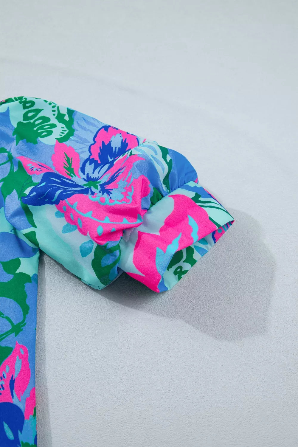 Vibrant floral print blouse with puff sleeves and a relaxed fit.