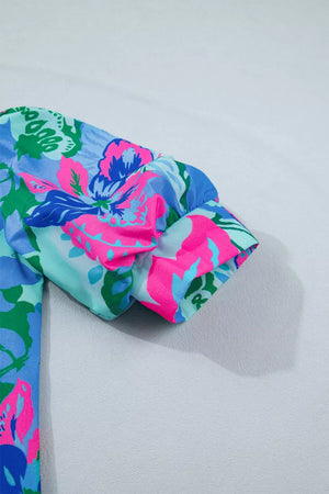 Vibrant floral print blouse with puff sleeves and a relaxed fit.