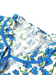 Floral ruffle sleeve tie-neck shirt with blue floral print and contrast trim.
