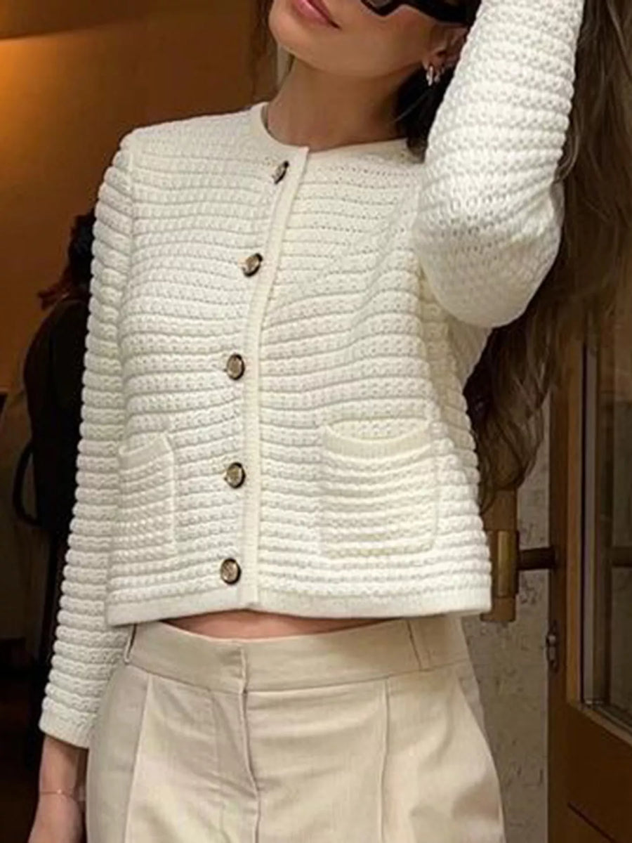 Textured white button-down cardigan with gold buttons and two front pockets.