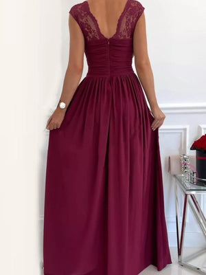 Burgundy maxi dress with lace cap sleeves and ruched bodice, featuring a high slit.