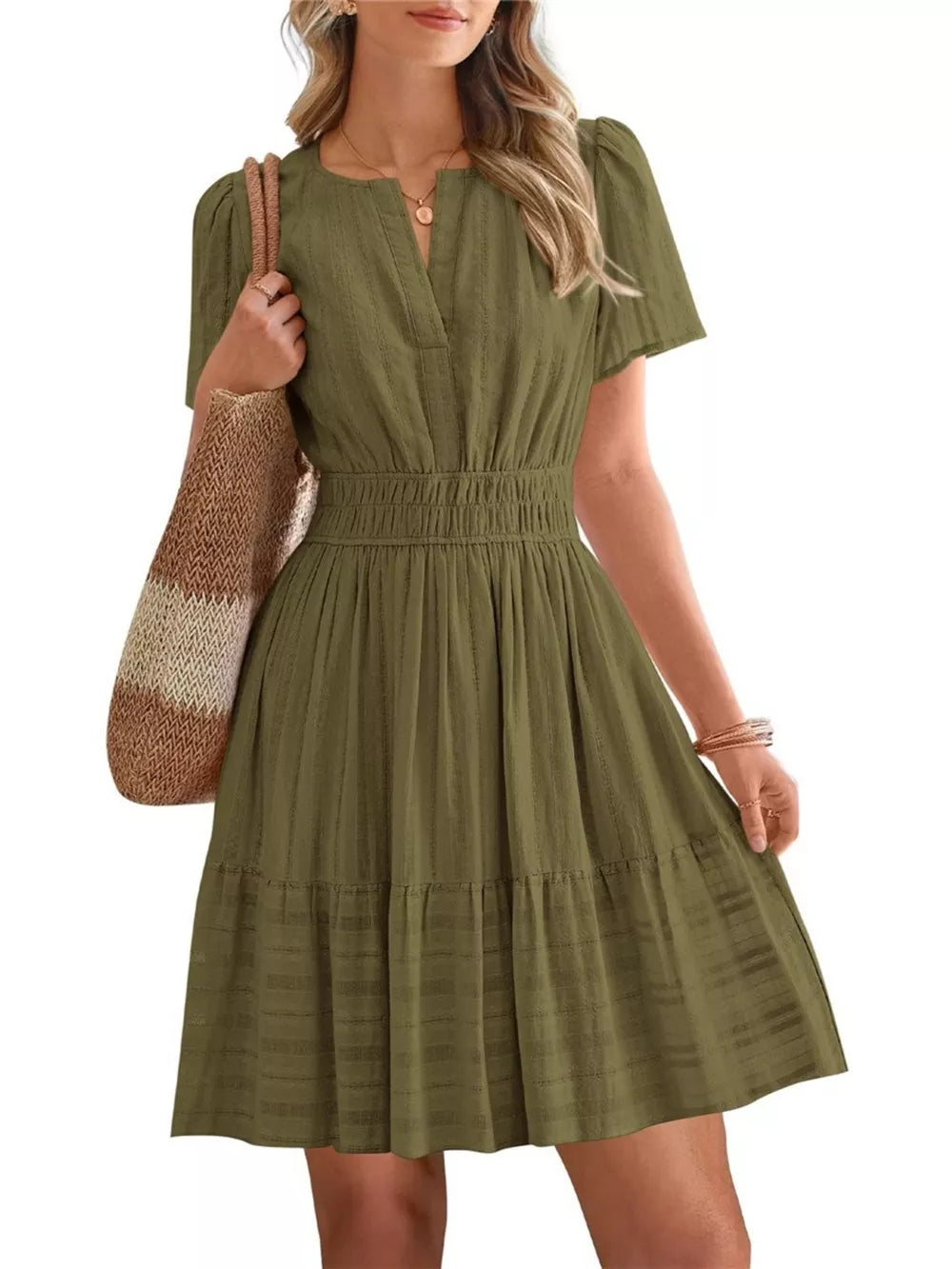 Army green textured V-neck tiered dress with smocked waist and short sleeves.