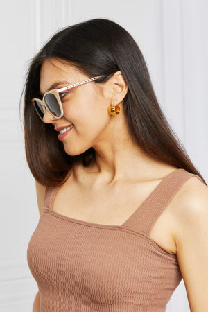 Cat-eye acetate sunglasses with chain detail on temples in mocha color.