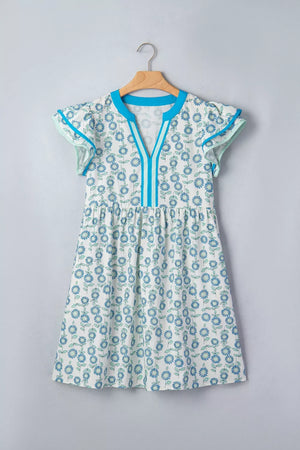 Floral print cotton blend dress with notched neckline, cap sleeves, and blue trim.