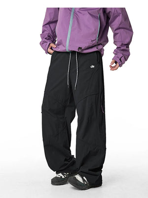 Relaxed fit black cargo pants with white drawstring and side zip pockets.
