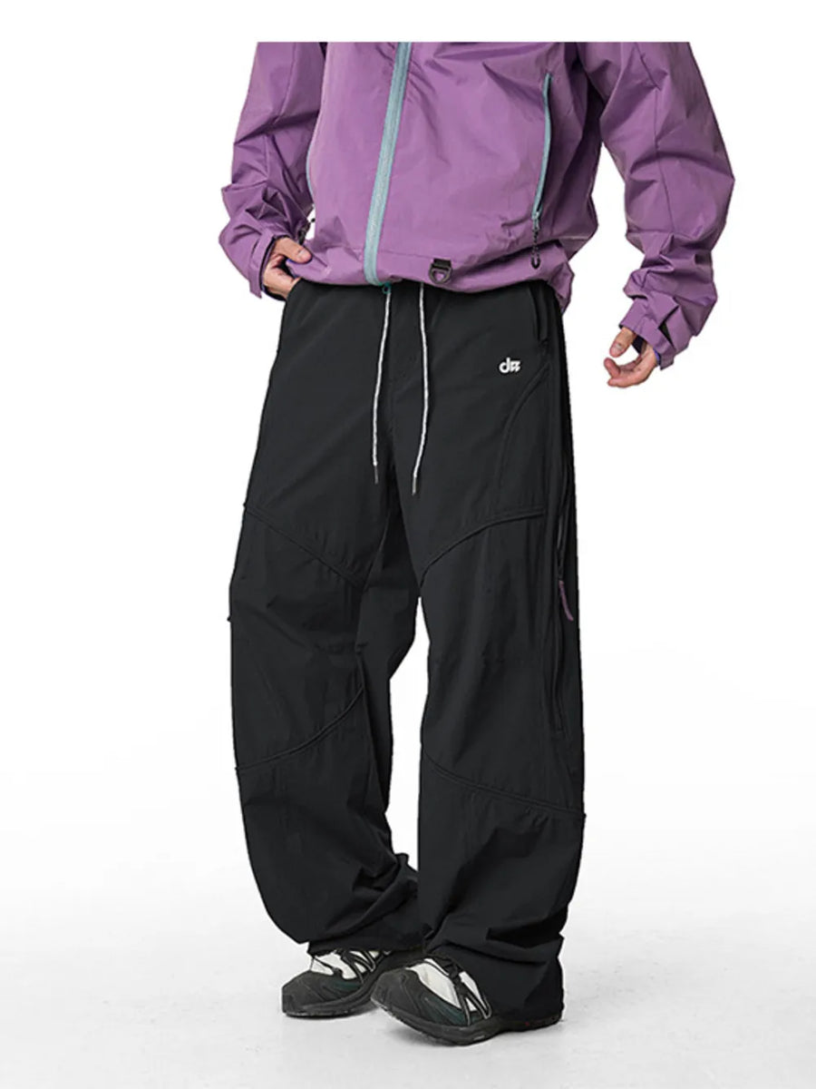 Relaxed fit black cargo pants with white drawstring and side zip pockets.