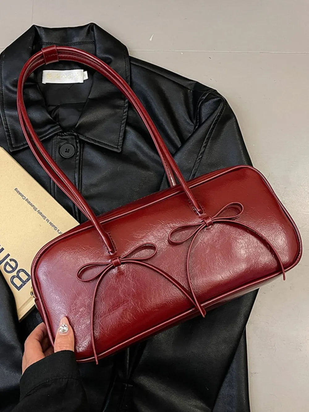 Burgundy patent leather shoulder bag with bow details
