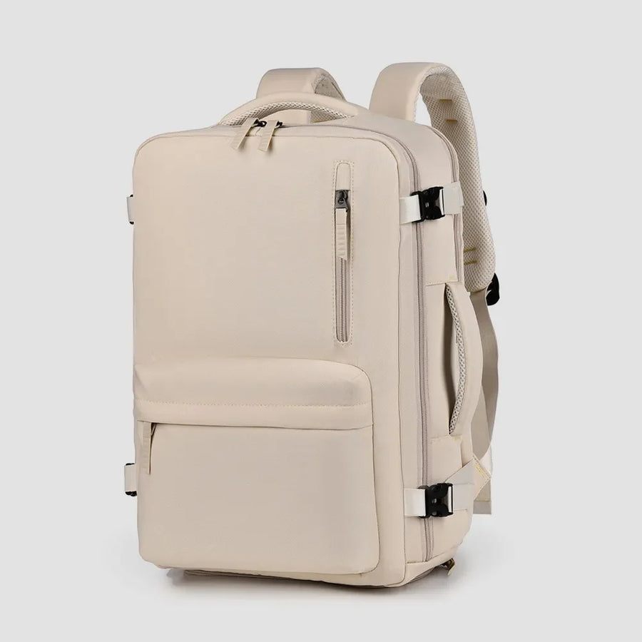 Beige travel backpack with zippered front pocket and side handle.