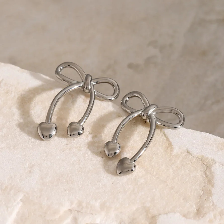 Silver bow drop earrings with heart charms
