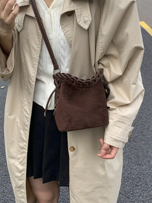 Brown suede mini crossbody bag with braided top detail and chain strap