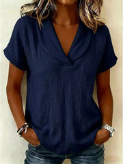 Navy blue textured blouse with short sleeves and a V-neck collar, styled casually.