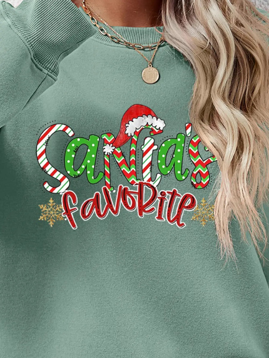 Sage green crewneck sweatshirt with Santa's Favorite festive graphic and snowflakes.