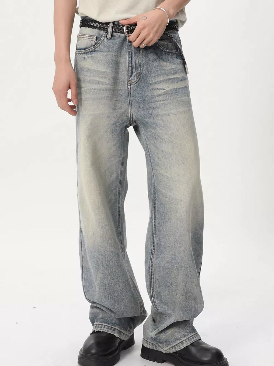 Men's vintage wash wide leg jeans in light blue denim with a relaxed fit.