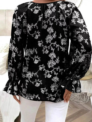 Black embroidered sheer long-sleeve blouse with ruffled cuffs.