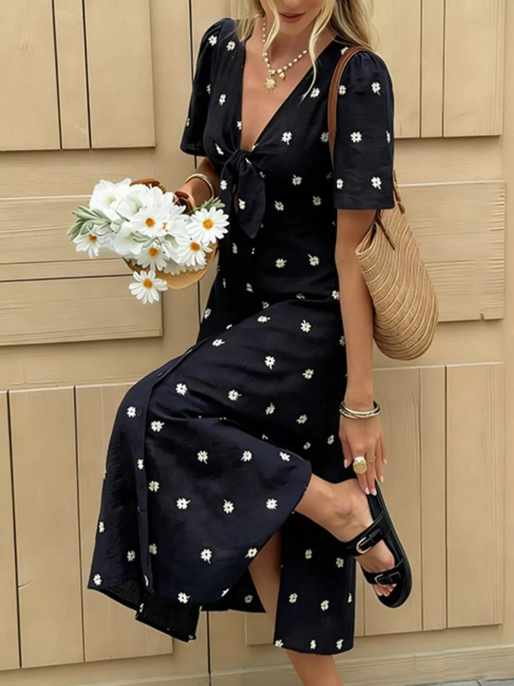 Navy blue daisy print midi dress with tie-front and short sleeves.