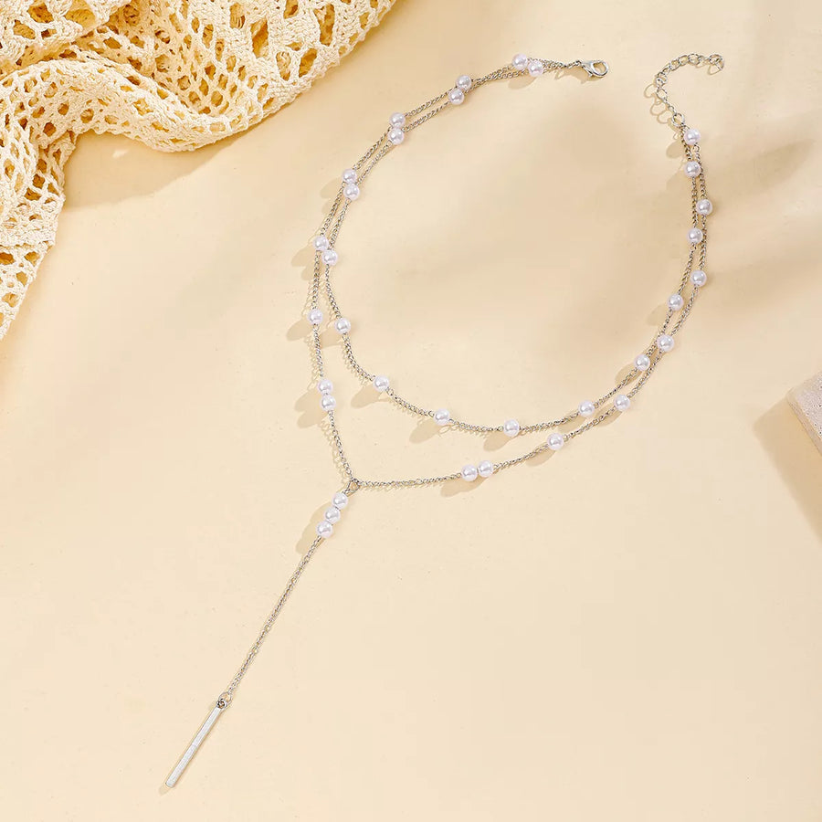 Silver double layered Y-shaped pearl necklace with a bar pendant.