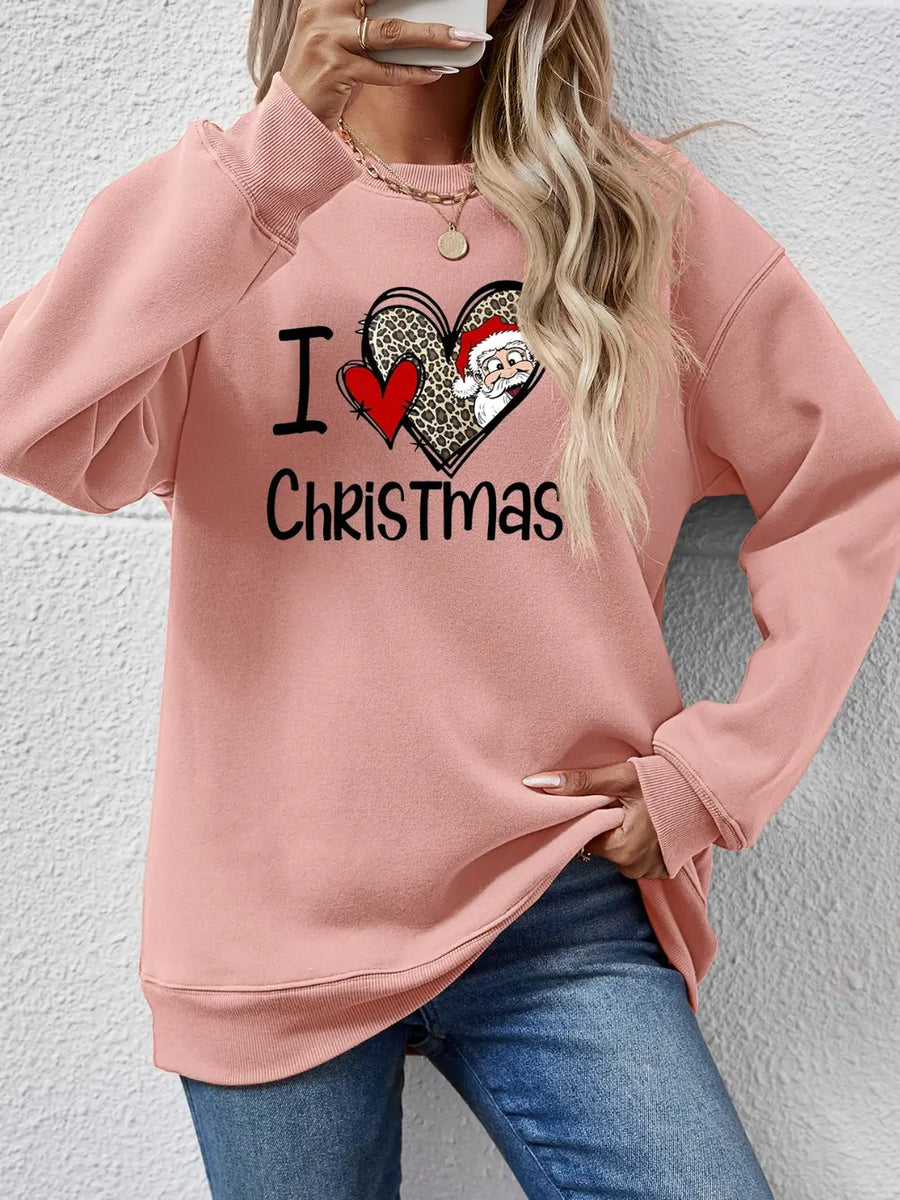 Blush pink crewneck sweatshirt with festive heart graphic and Santa Claus detail.