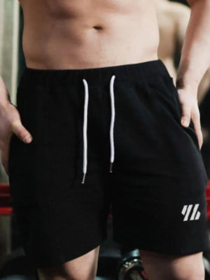 Black performance drawstring shorts with white logo detail and white drawstrings.