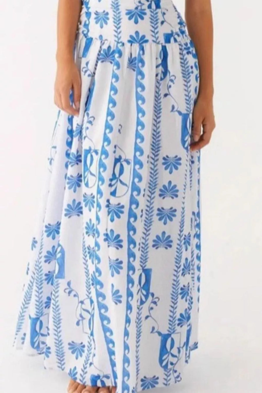 Light blue and white patterned maxi dress with a flowing skirt and ruched detail.