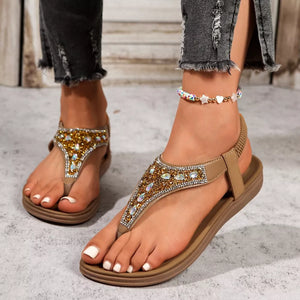Brown rhinestone-embellished toe post sandals with elastic heel strap and beaded anklet.