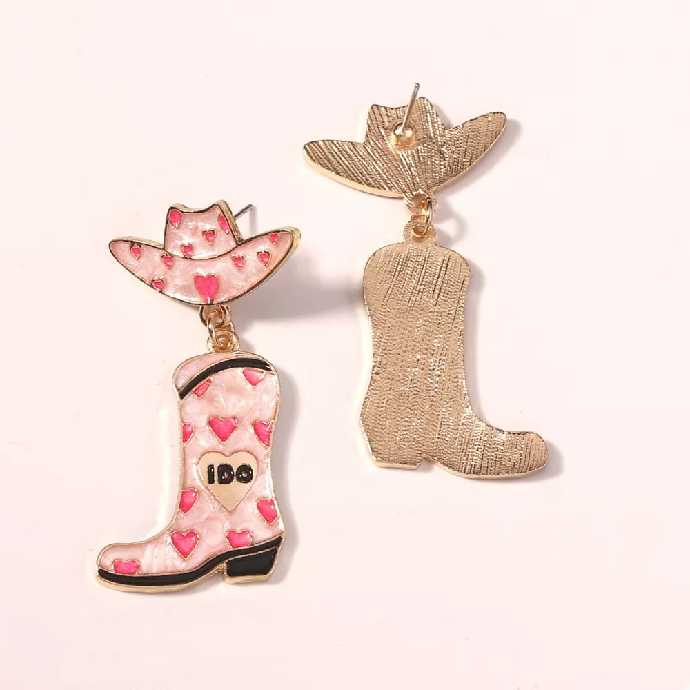 Pink cowgirl hat and boot earrings with heart pattern and gold detail.