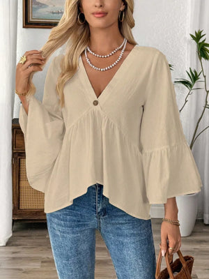 Apricot cotton V-neck blouse with bell sleeves and a button detail.
