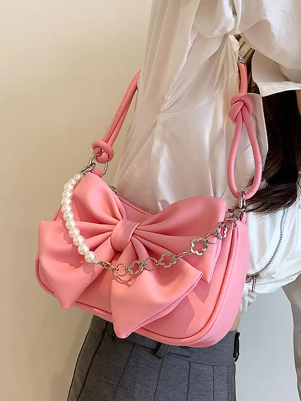 Pink bowknot shoulder bag with pearl chain and clover detail