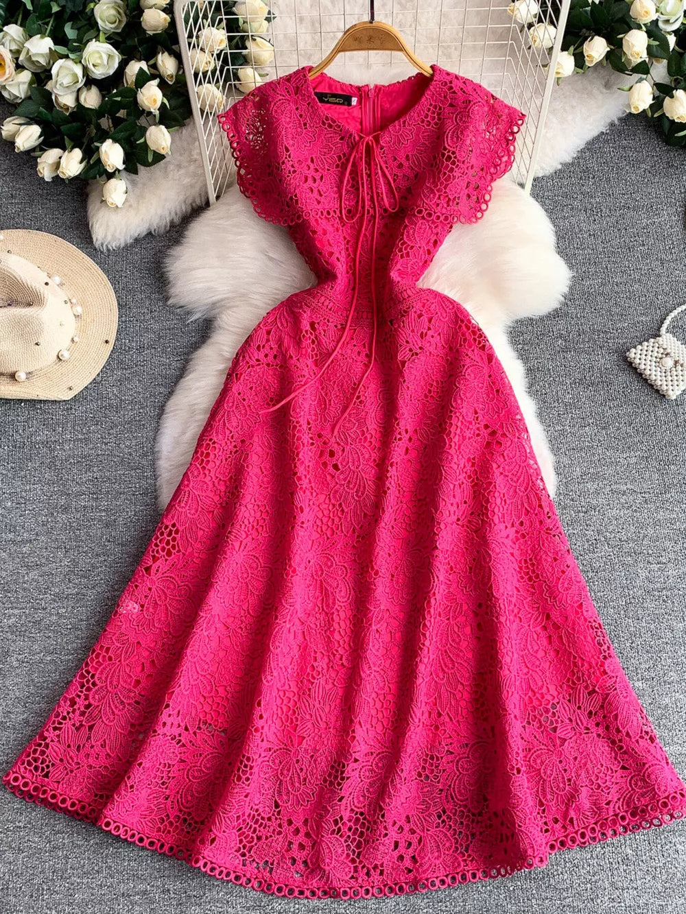 Fuchsia pink lace A-line dress with tie detail and cap sleeves.