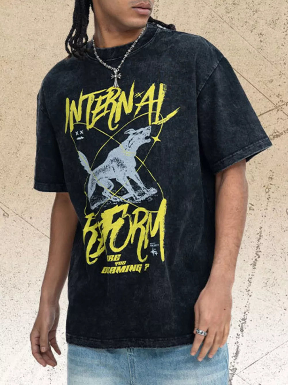 Men's washed black cotton t-shirt with howling wolf graphic and yellow text.