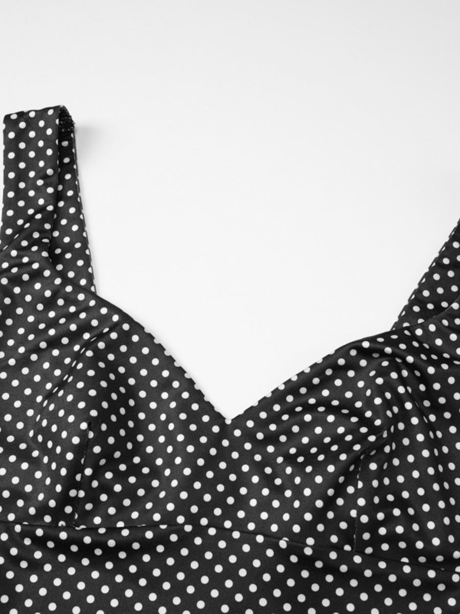 Black and white polka dot crop top with a V-neckline and wide straps.