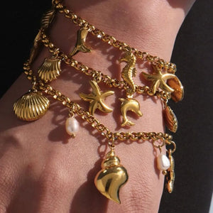 bracelet in gold featuring charm details and straight fit